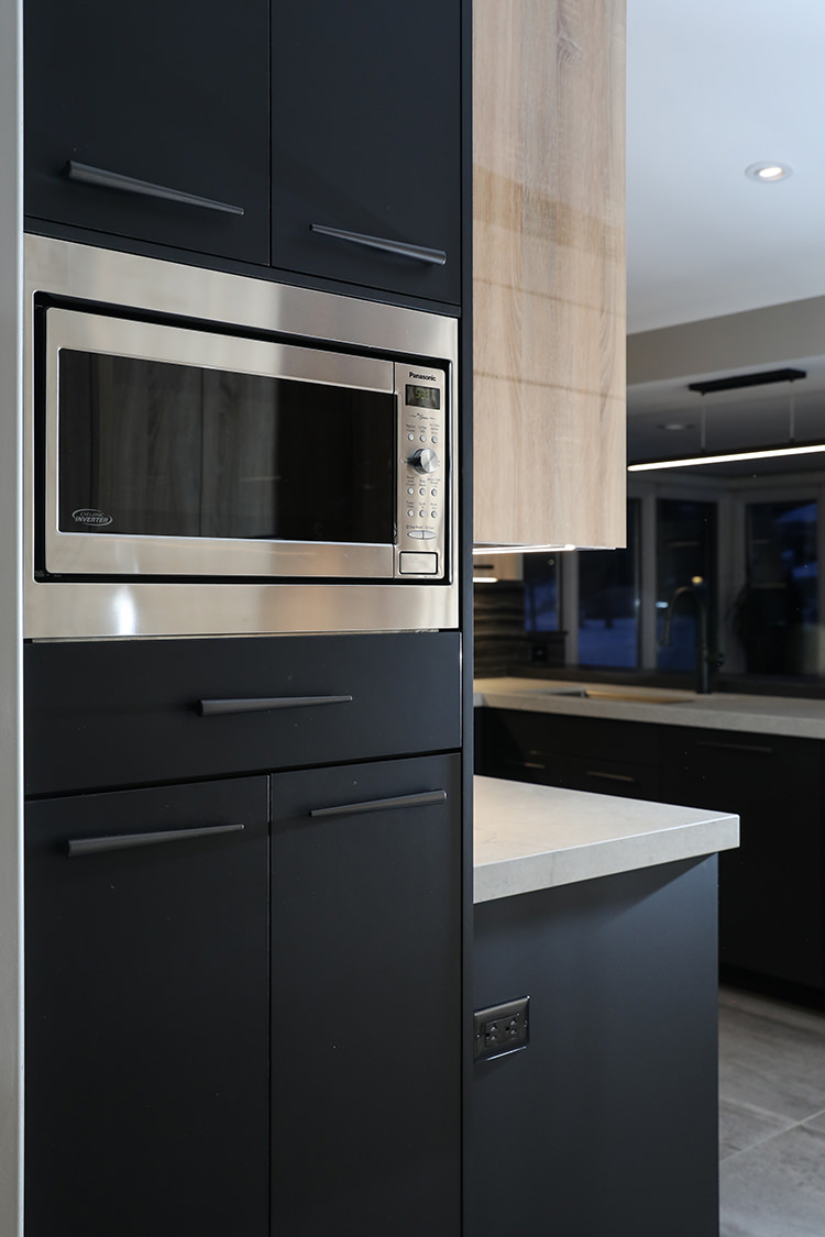 black cabinetry with built in microwave
