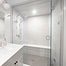 Marbled bathroom renovation with a large glass shower