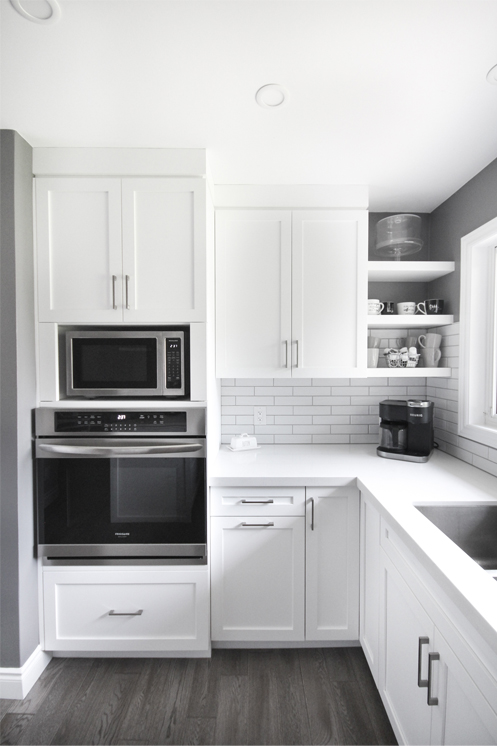 white countertops, cabinetry and subway tile