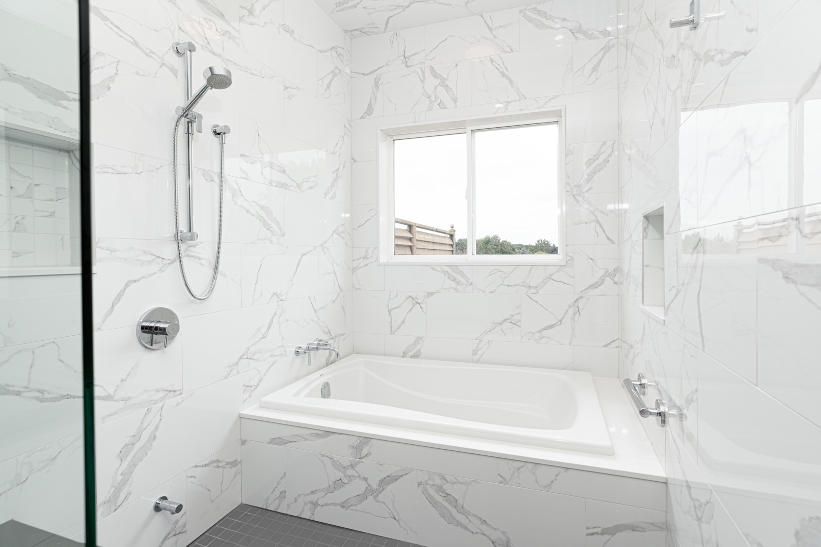 white marble tiled walls and bathtub