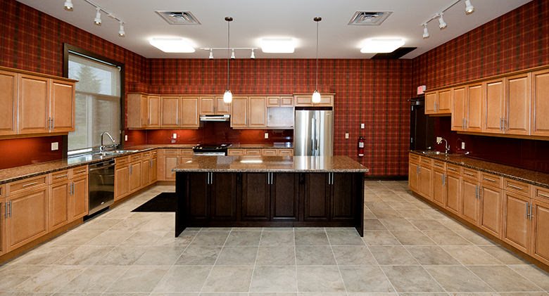 Grey title stone kitchen with dark wood workspace