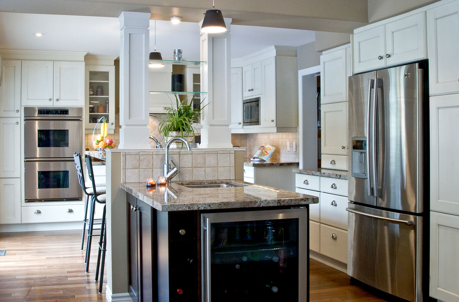 White kitchen design with hardwood floors and bar fridge - Total Living Concepts barrie ontario