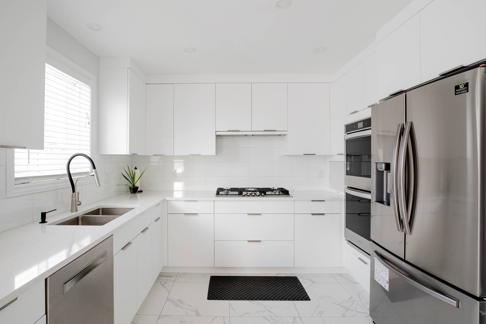 built-in kitchen appliances and white cabinetry