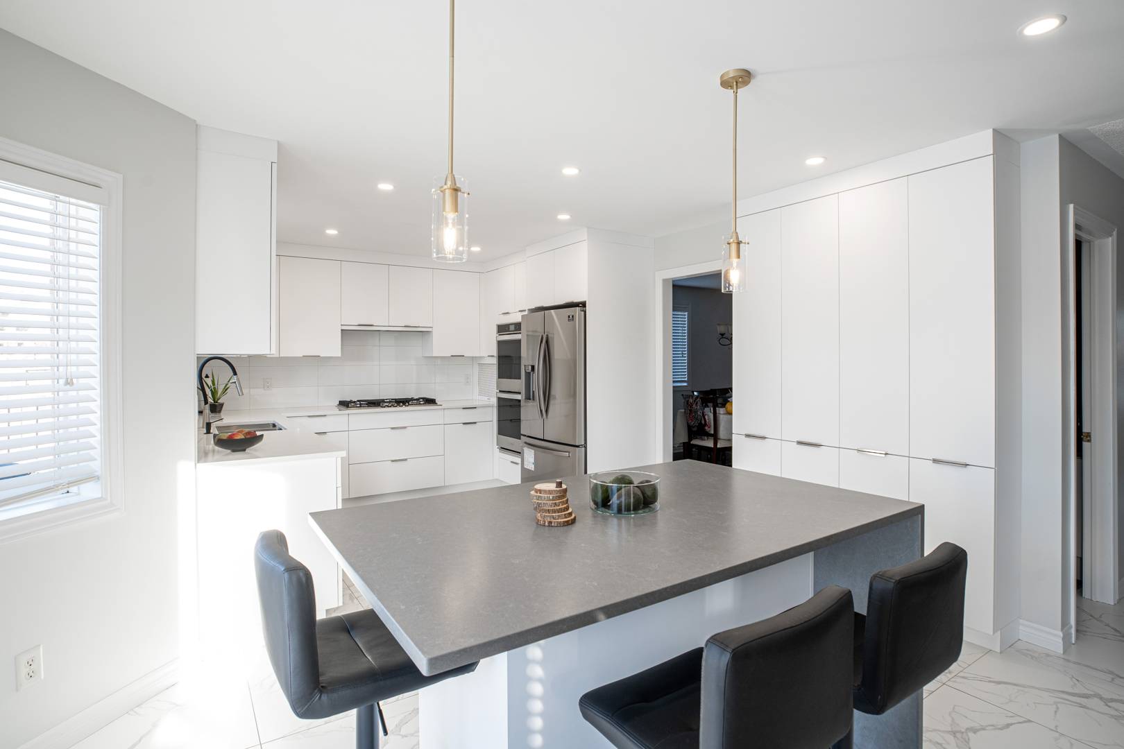 White kitchen design with extra cabinetry and a built-in kitchen island