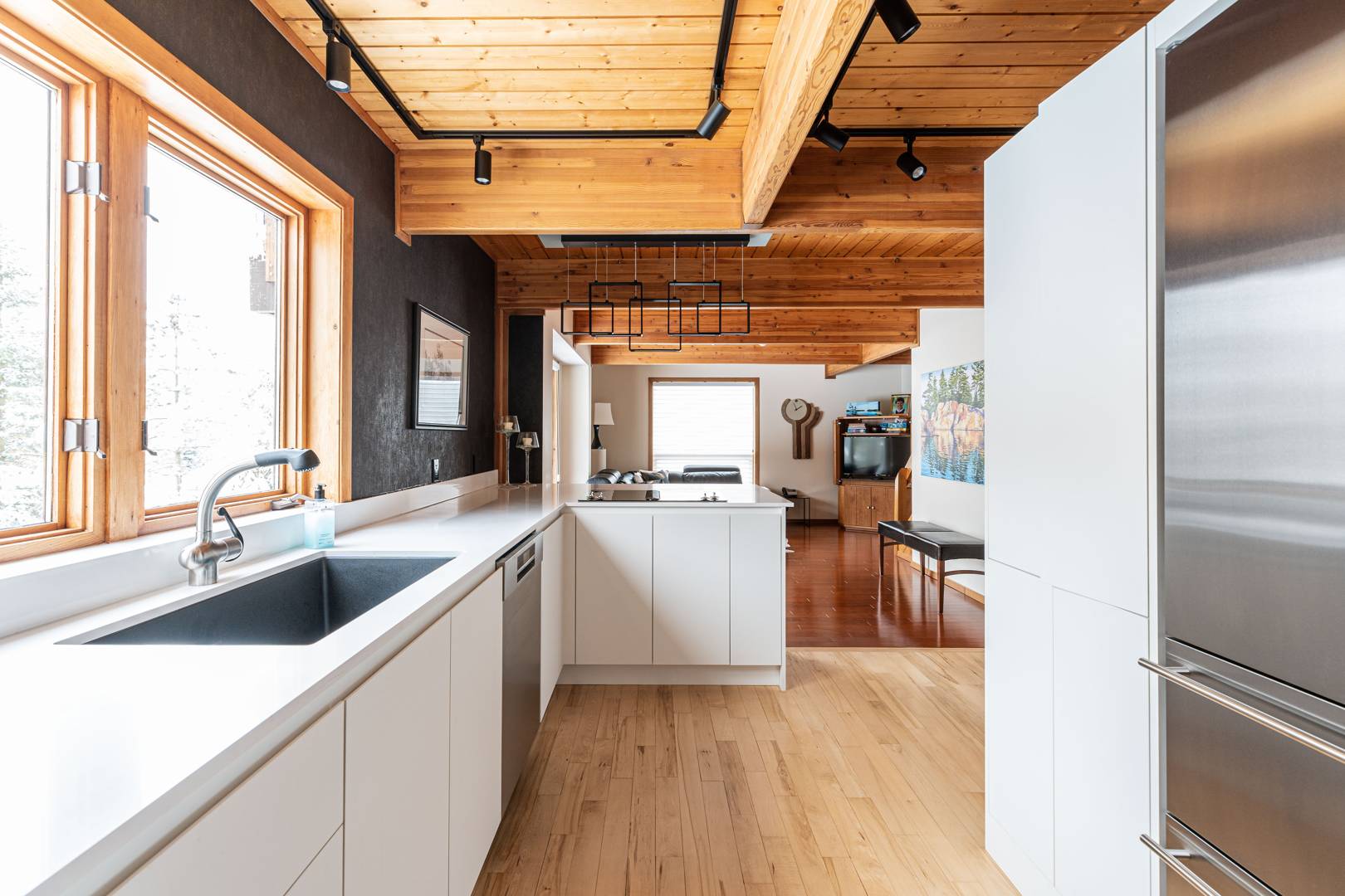 white kitchen cabinetry with wood ceiling