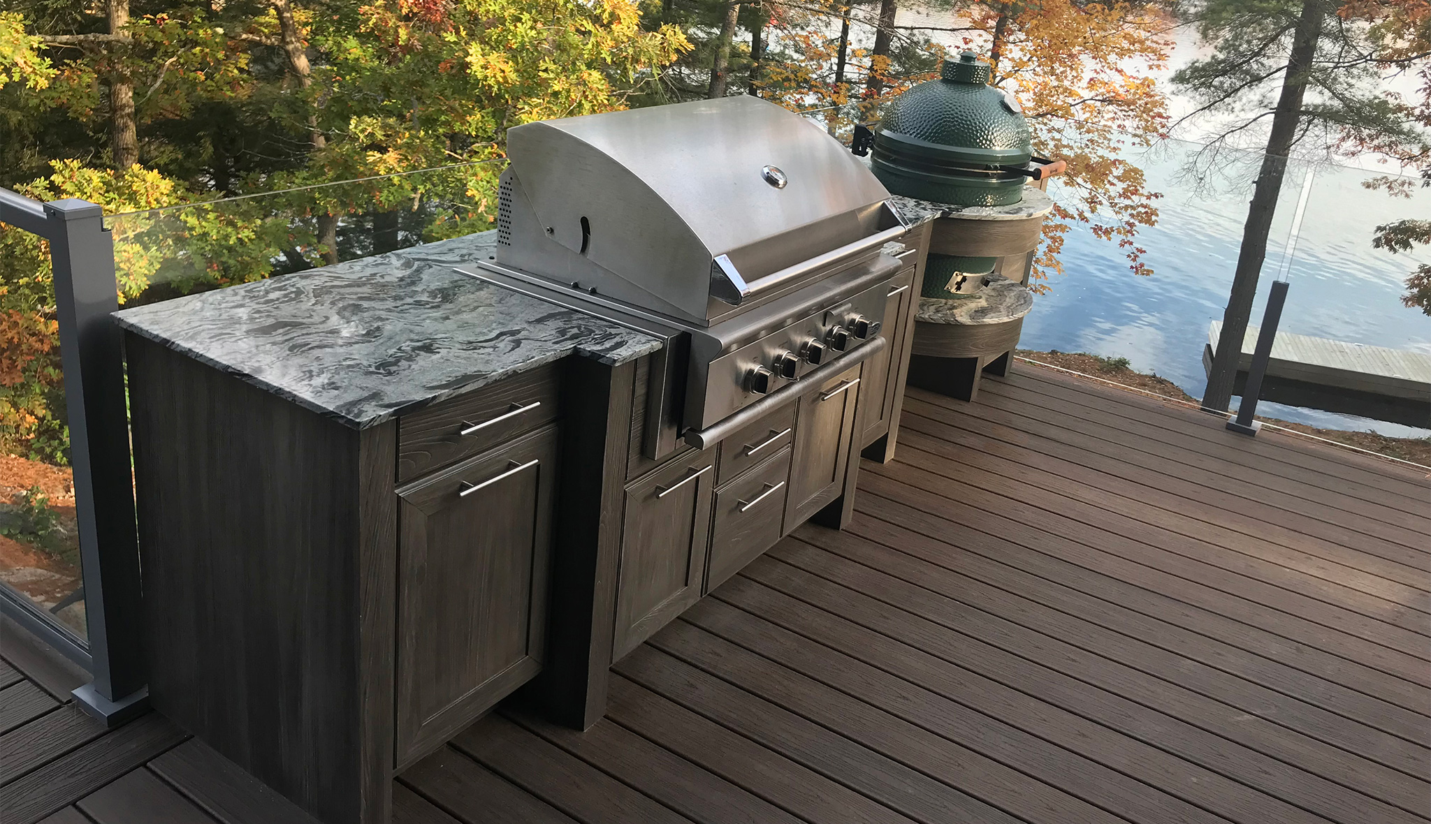 an outdoor kitchen with cabinetry and a BBQ