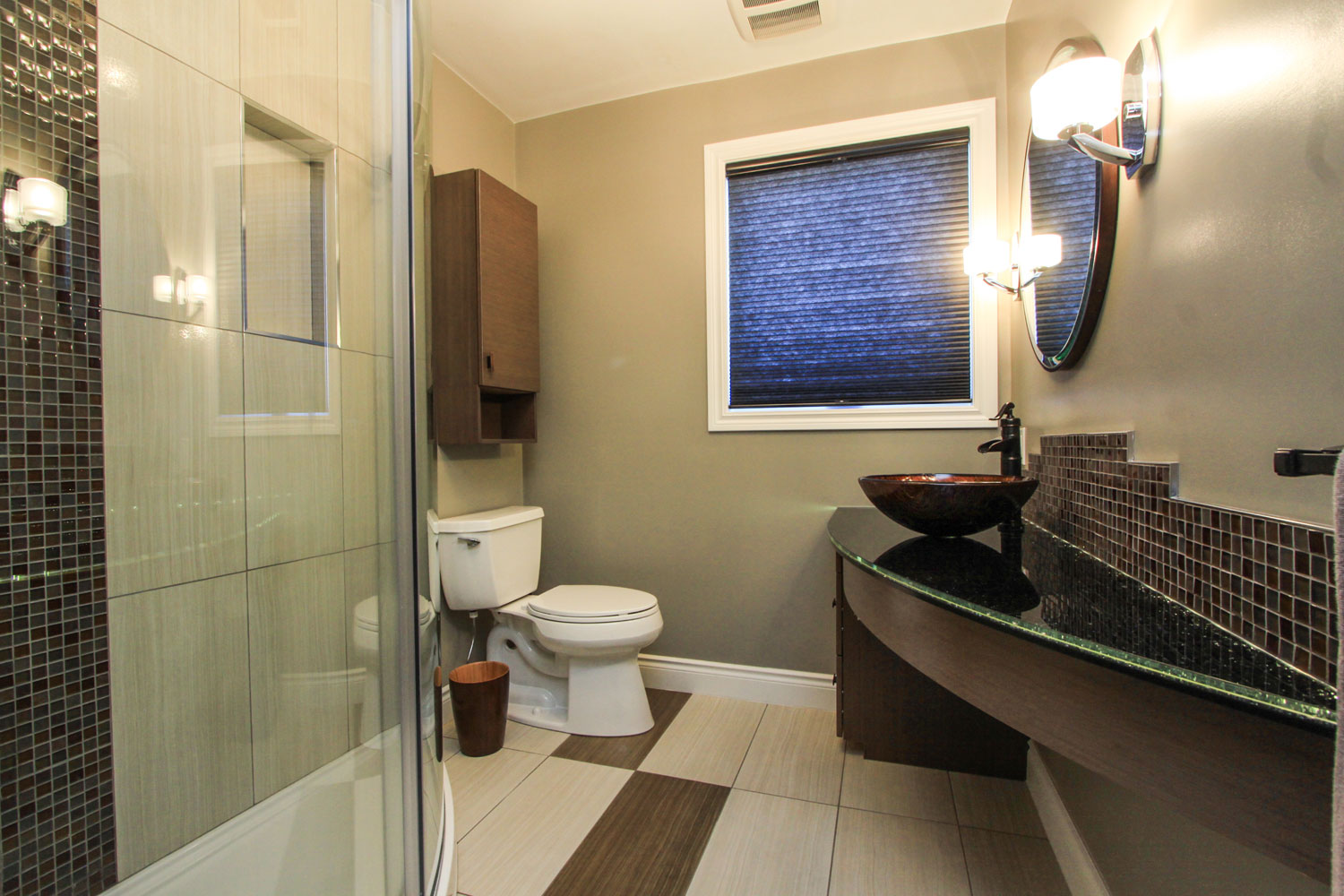 Eclectic modern main bathroom that features curved elements including a curved shower wall and vanity, round vessel sink, and circular mirror - Total Living Concepts in barrie ontario