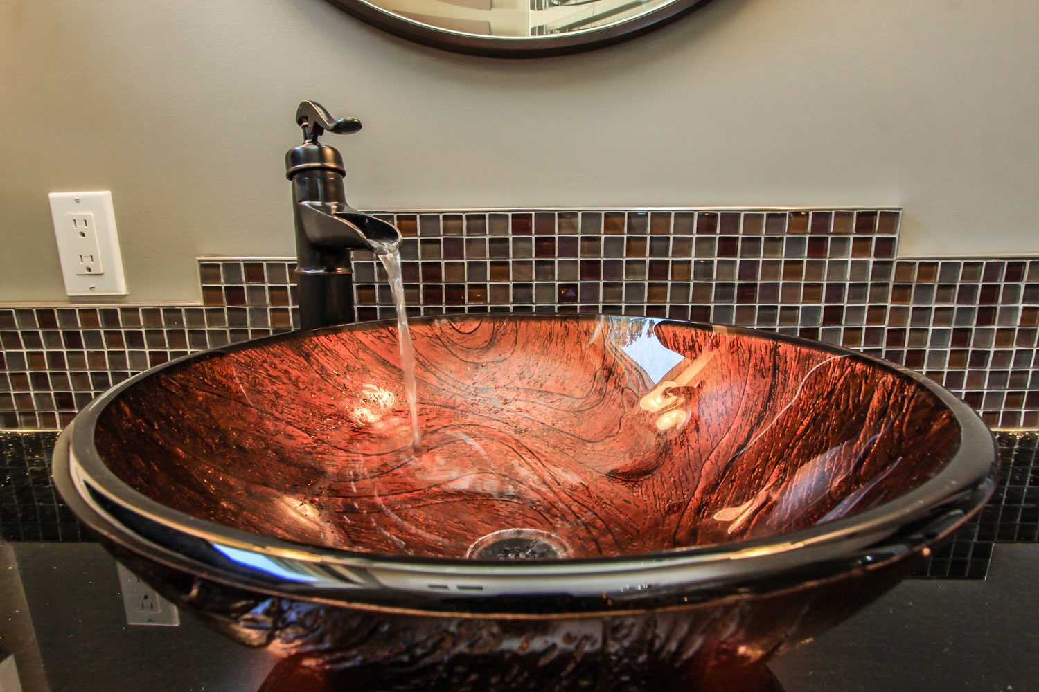 Beautiful red vessel sink with bronze farmhouse faucet and tile backsplash - Total Living Concepts in barrie ontario