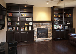 Basement living room renovation with gas fireplace and built-in shelving and storage - Total Living Concepts barrie ontario