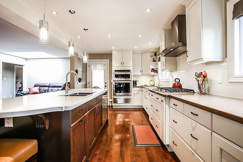 open kitchen with white cabinets and wood floors