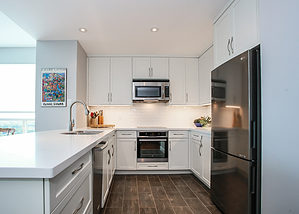 Small white kitchen design and renovation featuring white cabinets and stainless steel cabinets